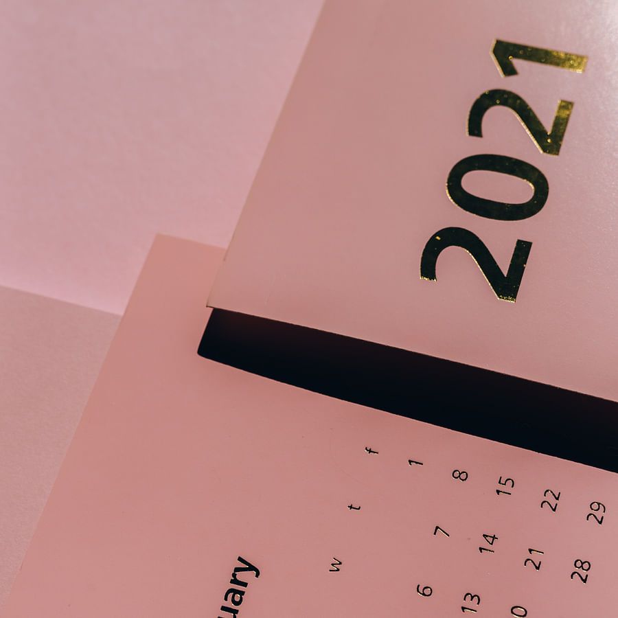 Cluttered desk with a traditional calendar and office supplies